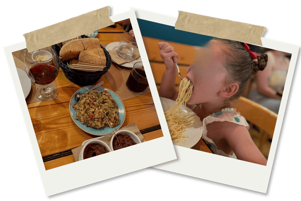Tamam houmous and dips and little girl eating spaghetti