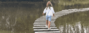 Stepping stones at Martin Mere with girl running over them