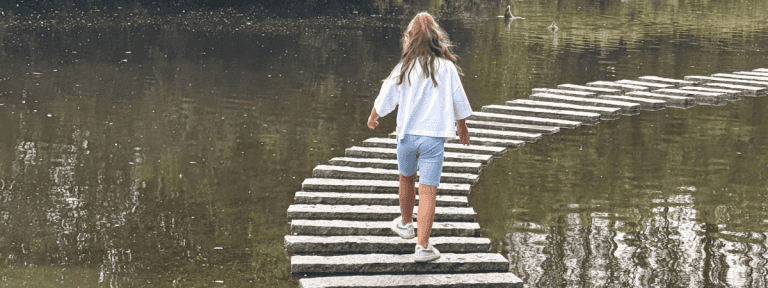 Stepping stones at Martin Mere with girl running over them